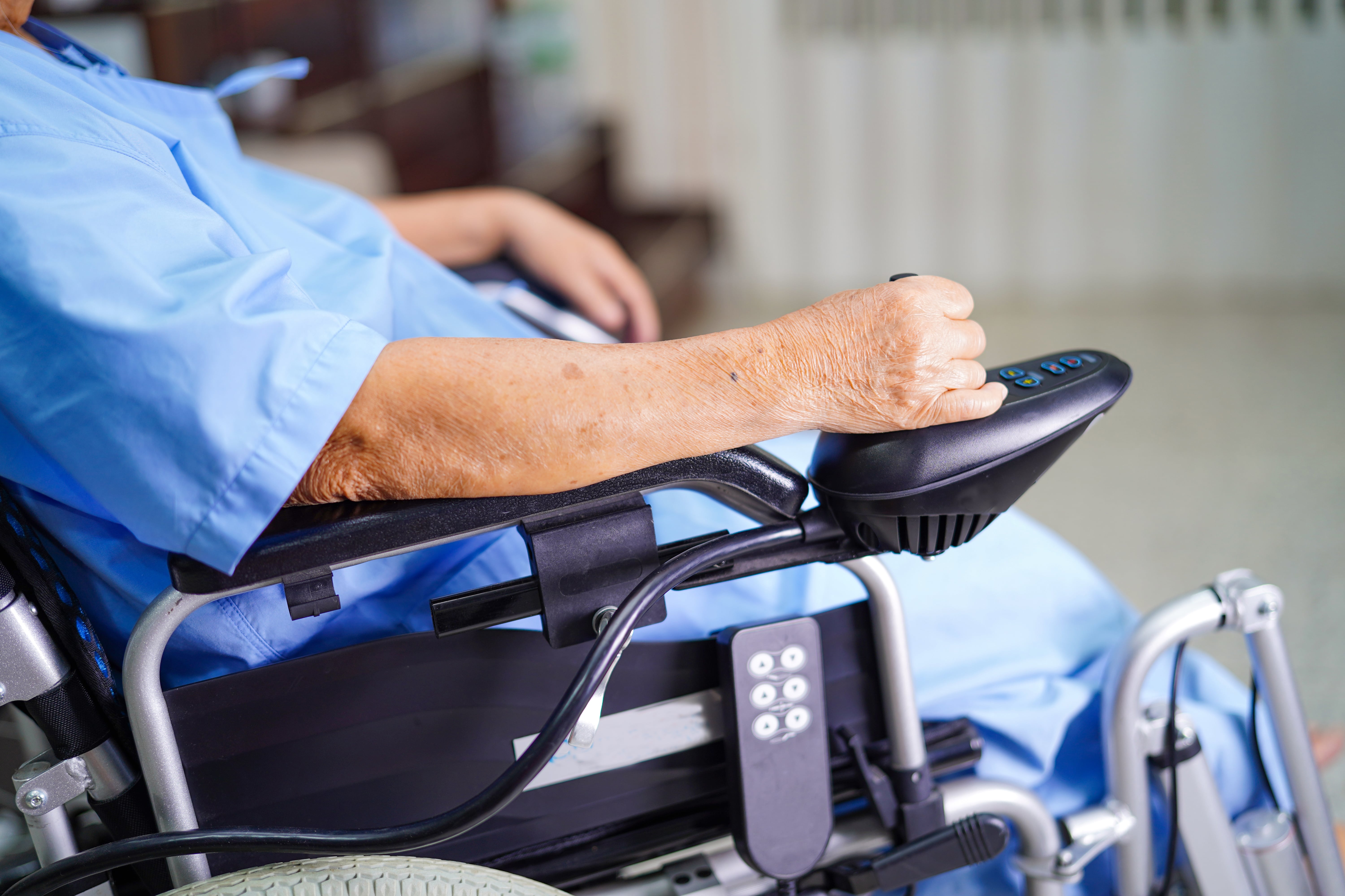 Man's arm operating an electric wheelchair